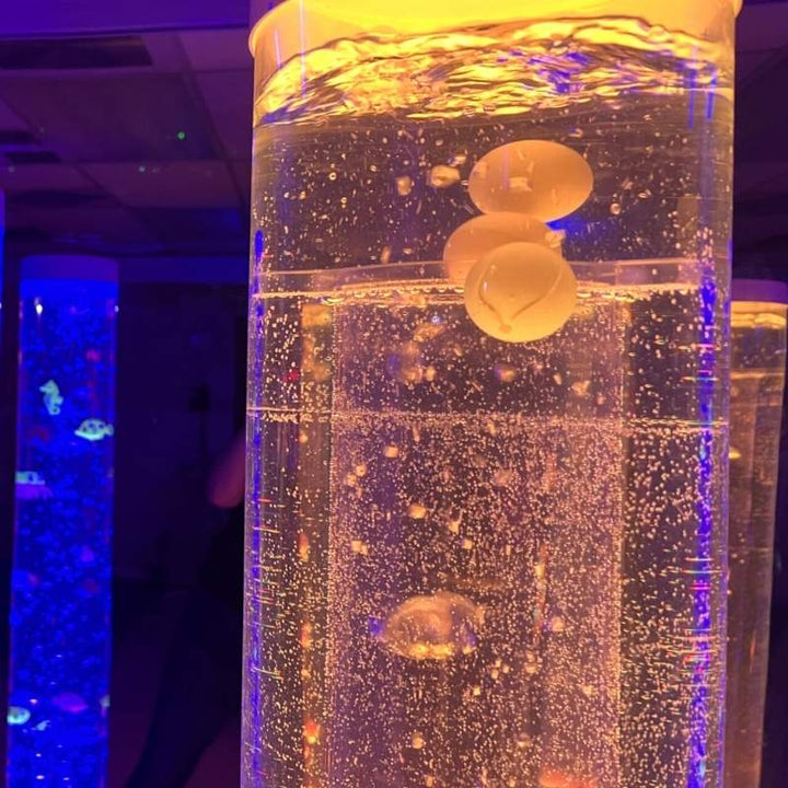 TFH 8" Bubble Tube Insert - Cascading Balls & Beads - close up view in yellowish tube with blue light tube in the background