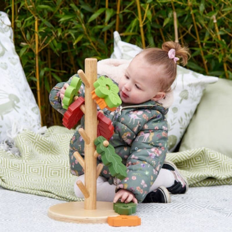TTSOutdoorPostingTree_1- girl playing with the tree