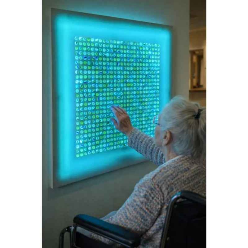 Close-up of the AHS Marvelous Sensory Marble Wall Panel steel grid showing iridescent marbles for tactile and visual sensory exploration