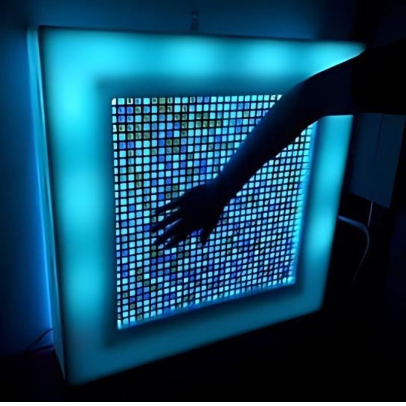 AHS Sensory Marble Wall Panel with LED lighting casting a warm glow through the iridescent steel grid, ideal for sensory rooms and therapy spaces