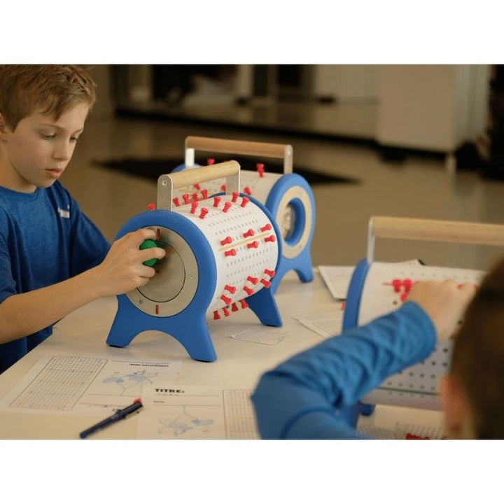 Two children playing together with Ara Musique The Ara programmable music box, showing collaborative music composition and melody creation for elementary classrooms