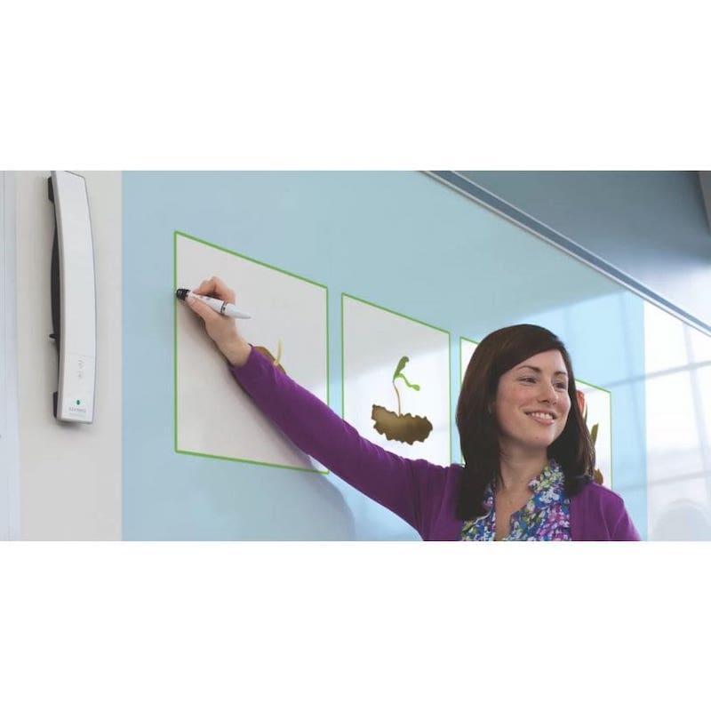 Teacher writing on a Boxlight MimioTeach interactive whiteboard surface with the rechargeable stylus, showing the patented infrared and ultrasound tracking in a classroom setting
