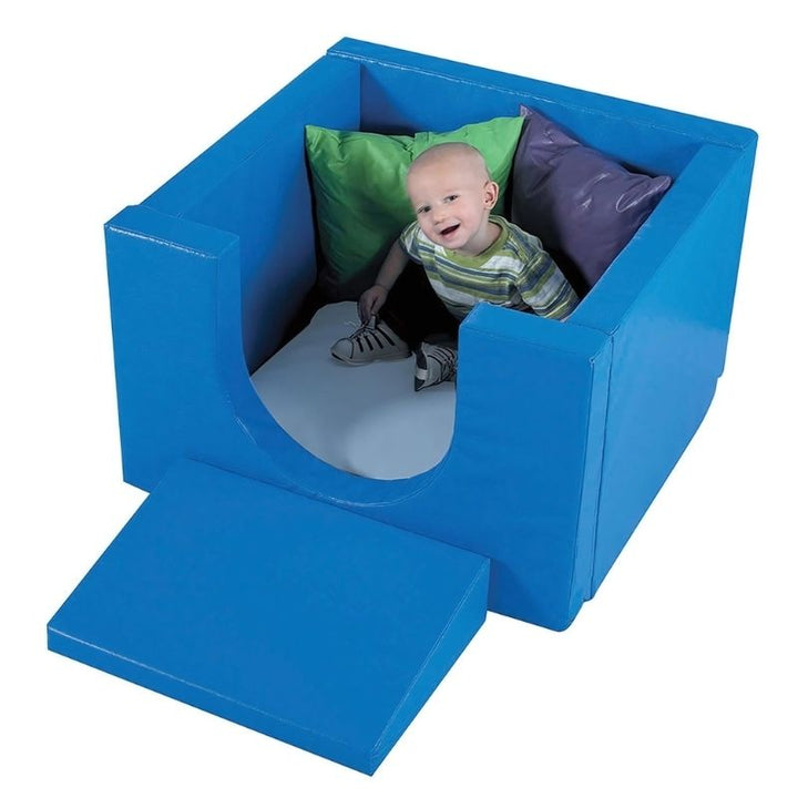 Top view of the Children's Factory Cozy Cube with a child playing inside, showing the open roof design, cushioned floor, and 3-inch foam walls of this soft play quiet space