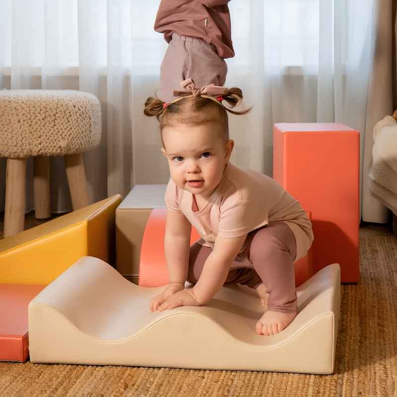 Baby crawling over the wave-shaped piece of the IGLU Discoverer Soft Play Set in Pastel Fries