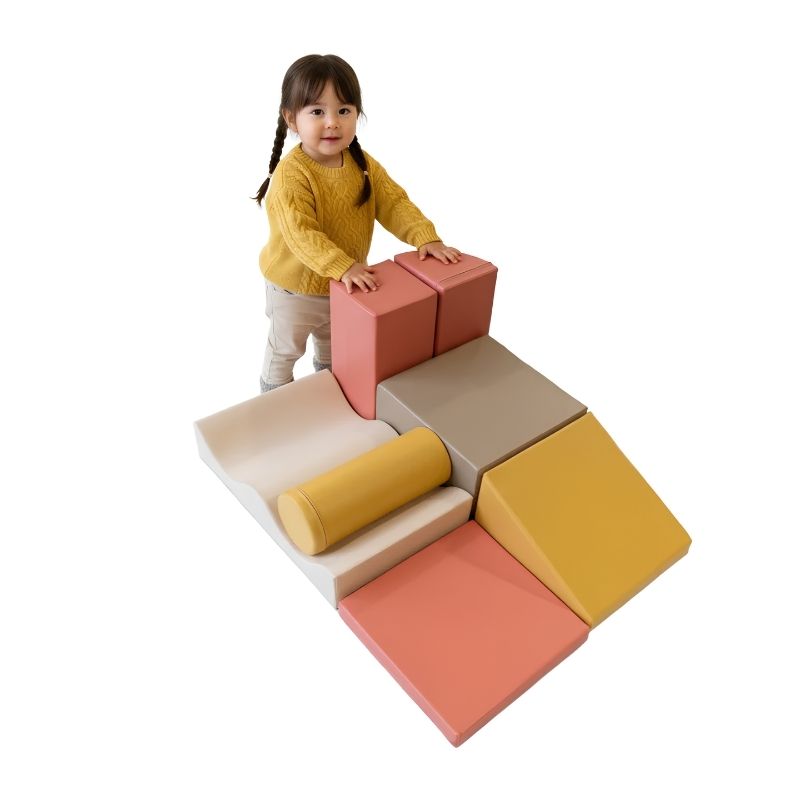Toddler girl standing on the IGLU Discoverer Soft Play Set in Pastel Fries, supporting gross motor and balance skills