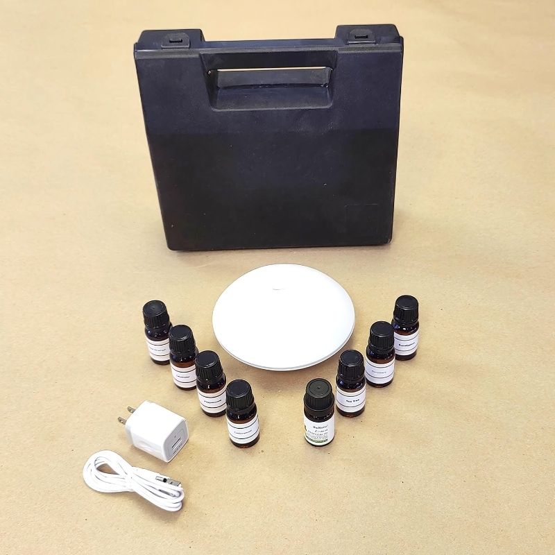 Experia Aroma Starter Kit top view showing the complete set with USB-powered aroma diffuser, sturdy carrying case, and eight 10ml essential oils for sensory room aromatherapy