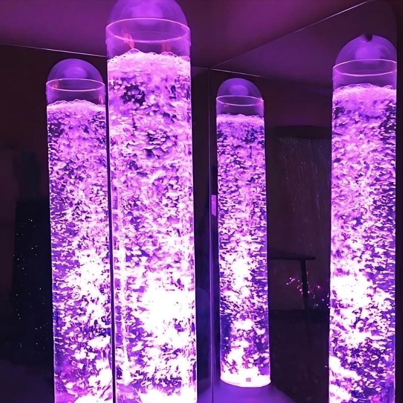 Close-up of the Experia Bubble Tube Mirrors in purple light, showing the shatter-resistant acrylic surface and corner-mounted installation reflecting the bubble tube colour