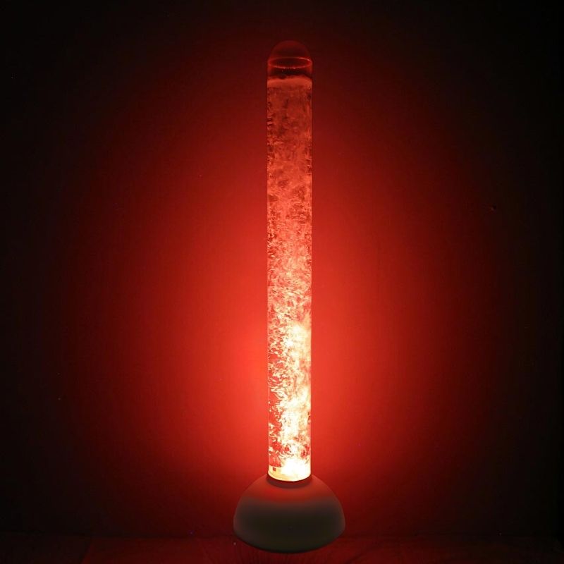 Experia Calming LED Bubble Tube landscape view glowing in red light in a dark sensory room, showing the auto colour-cycling 60-inch bubble tube with no controller required