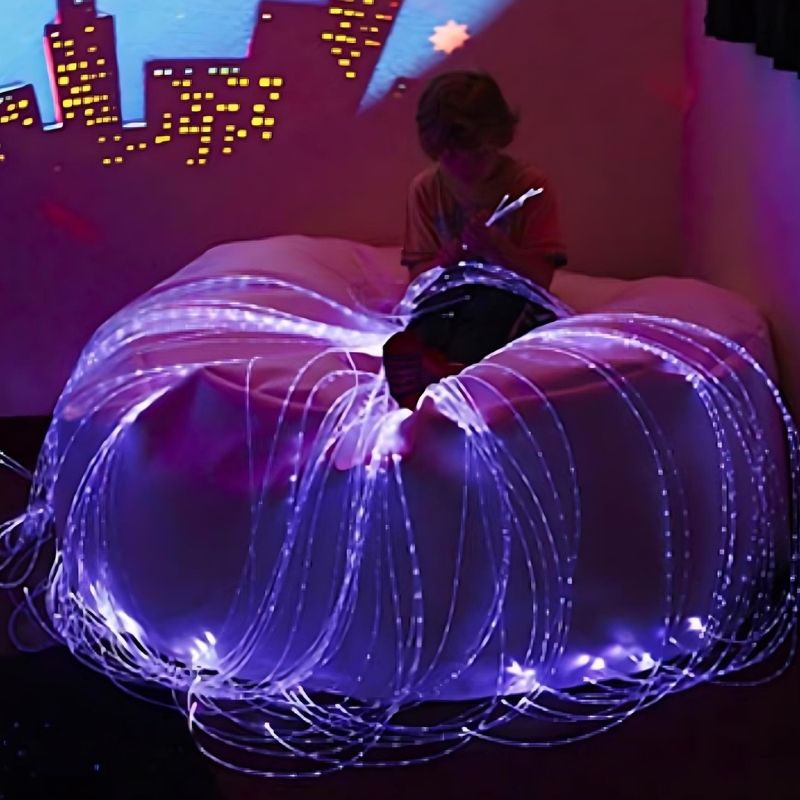 Child actively exploring the Experia Calming Sensory Room, showing the immersive plug-in multi-sensory bundle in use for calming and sensory regulation