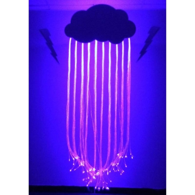 Experia Fibre Optic Raincloud front view in purple light showing 150 colour-changing fibre optic raindrop strands hanging from the wall-mounted cloud enclosure with decorative thunderbolts