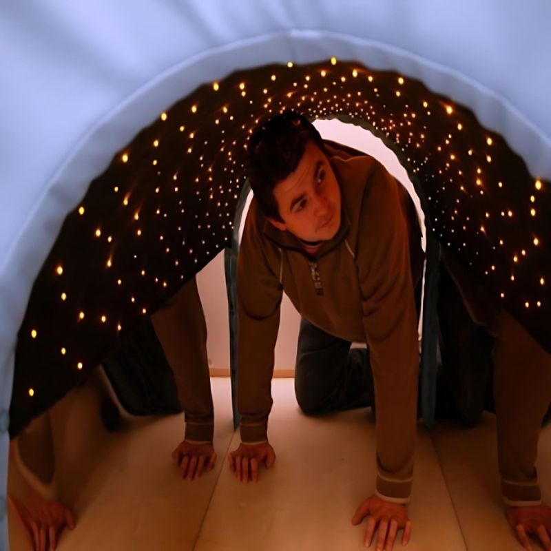 Adult entering the Experia Fibre Optic Tranquility Tunnel demonstrating the tunnel is suitable for all ages and the Calming and Superactive fibre optic sensory experience
