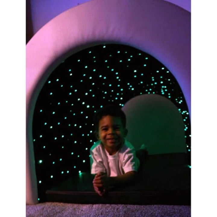 Boy crawling inside the Experia Fibre Optic Tranquility Tunnel experiencing the colour-changing fibre optic interior of the sensory hideaway tunnel