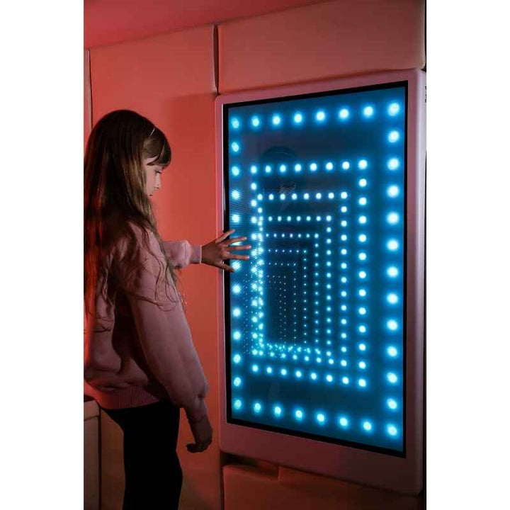 Teen engaging with the Experia Intelli Panel Infinity interactive sensory wall panel in blue light