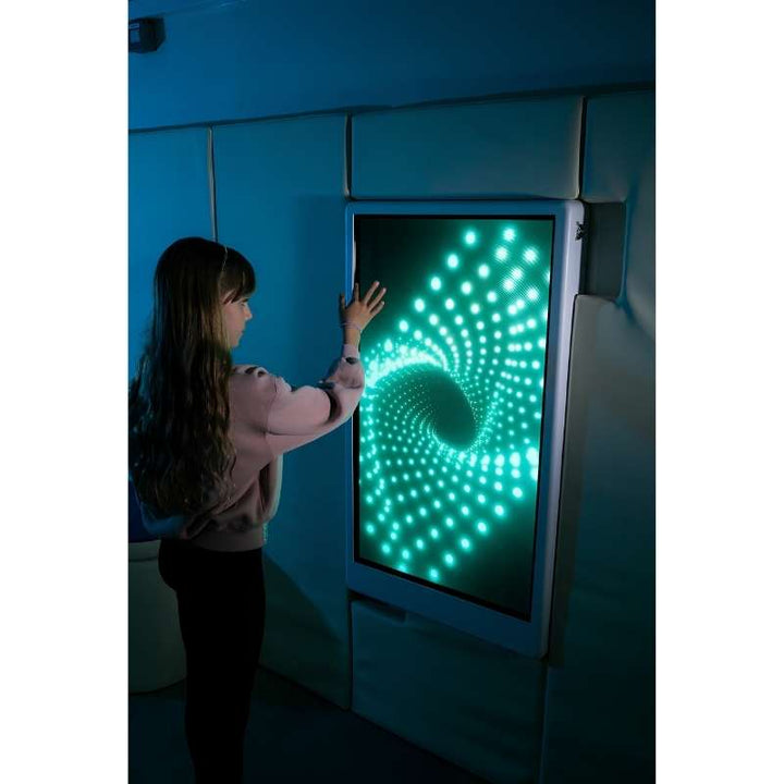 Teen engaging with the Experia Intelli Panel Infinity interactive sensory panel displaying cyan light effects