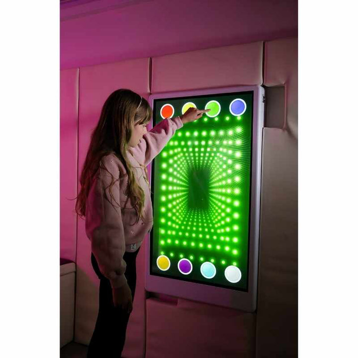 Teen engaging with the Experia Intelli Panel Infinity interactive sensory wall panel displaying green light effects