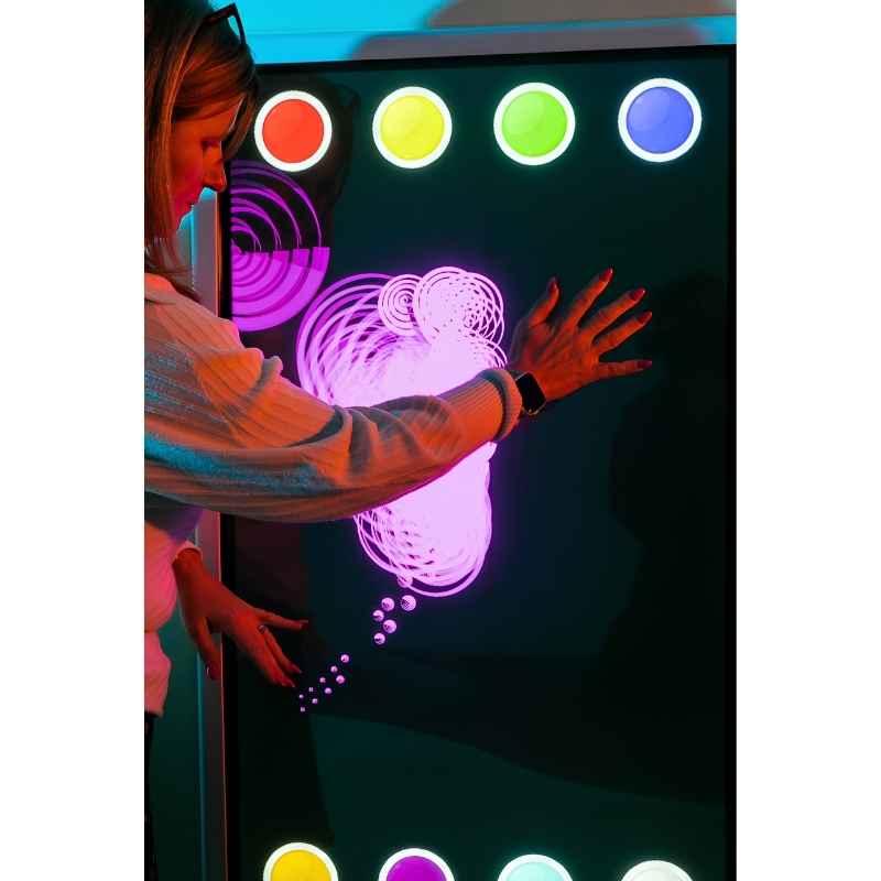 Close-up of adult engaging with the Experia Intelli Panel Musical Touch sensory wall panel in multicolour display mode