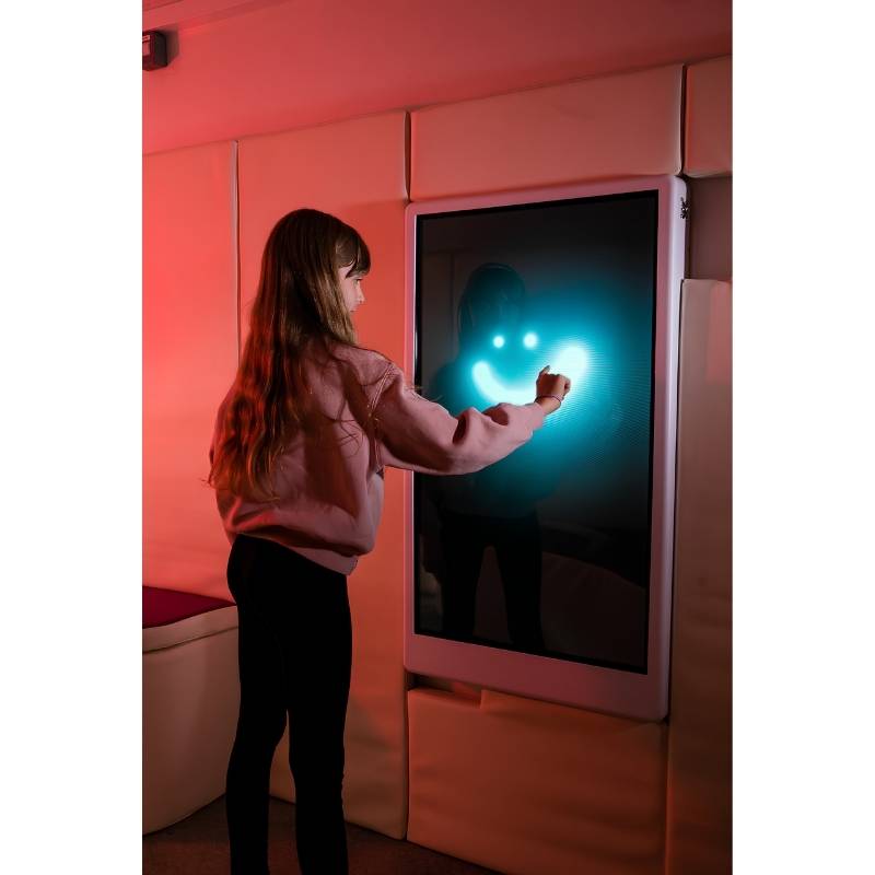 Adult engaging with the Experia Intelli Panel Musical Touch sensory panel displaying a smiley face pattern in a red-lit room