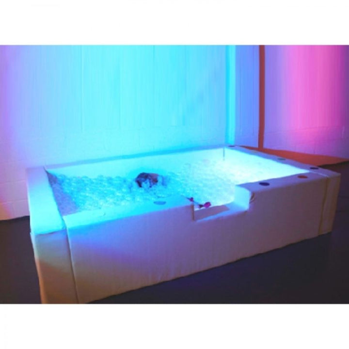 Experia Interactive LED Ball Pool in blue-pink light showing the colour-changing LED illumination across all translucent balls in the large sensory ball pool