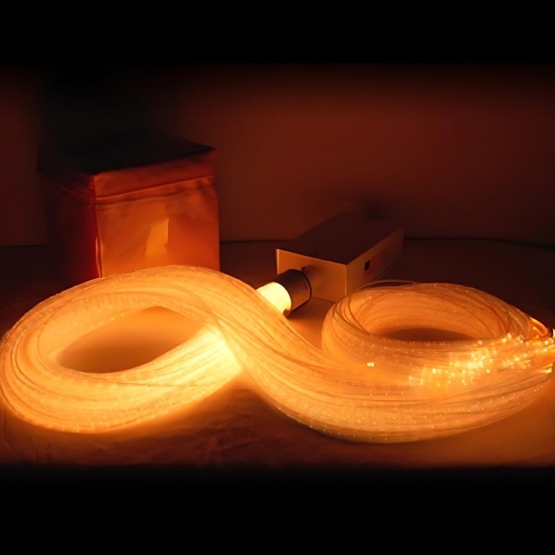 Close-up of the Experia IRiS LED Fibre Optic Bundle with Qube in orange light showing the colour-changing LED fibre optic strands controlled by rolling the IRiS Qube