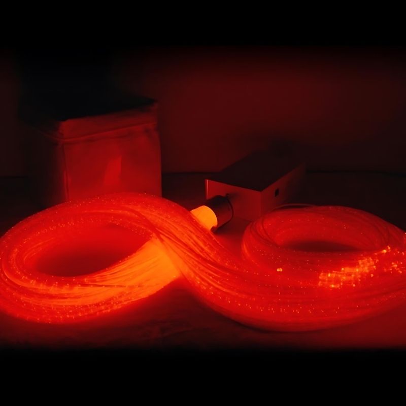 Close-up of the Experia IRiS LED Fibre Optic Bundle with Qube in red light showing the vivid colour-changing fibre optic strands of the wireless IRiS sensory bundle
