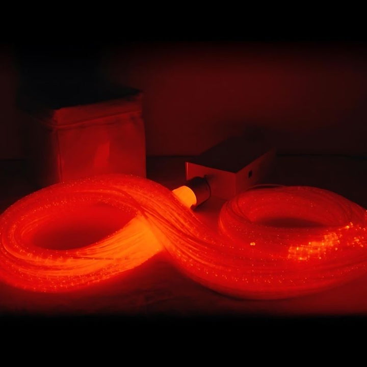 Close-up of the Experia IRiS LED Fibre Optic Bundle with Qube in red light showing the vivid colour-changing fibre optic strands of the wireless IRiS sensory bundle