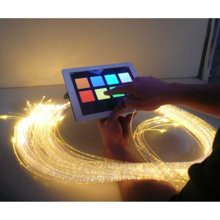 Top view of the Experia IRiS+ LED Fibre Optic Bundle with iConverter showing a user pressing the IRiS+ App on an Apple device to wirelessly control the fibre optic strands