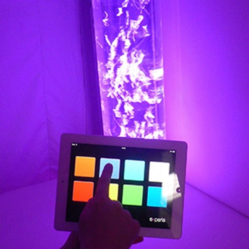 Close-up of the Experia IRiS+ iConverter active touch interaction showing a user engaging the touch switch type on the Apple device to control their IRiS Listeners wirelessly