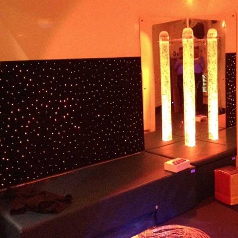 Experia LED Fibre Optic Sensory Wall Carpet full room view in orange light showing the 80-inch wide wall-mounted fibre optic carpet with hundreds of safe-to-touch colour-changing LED spots