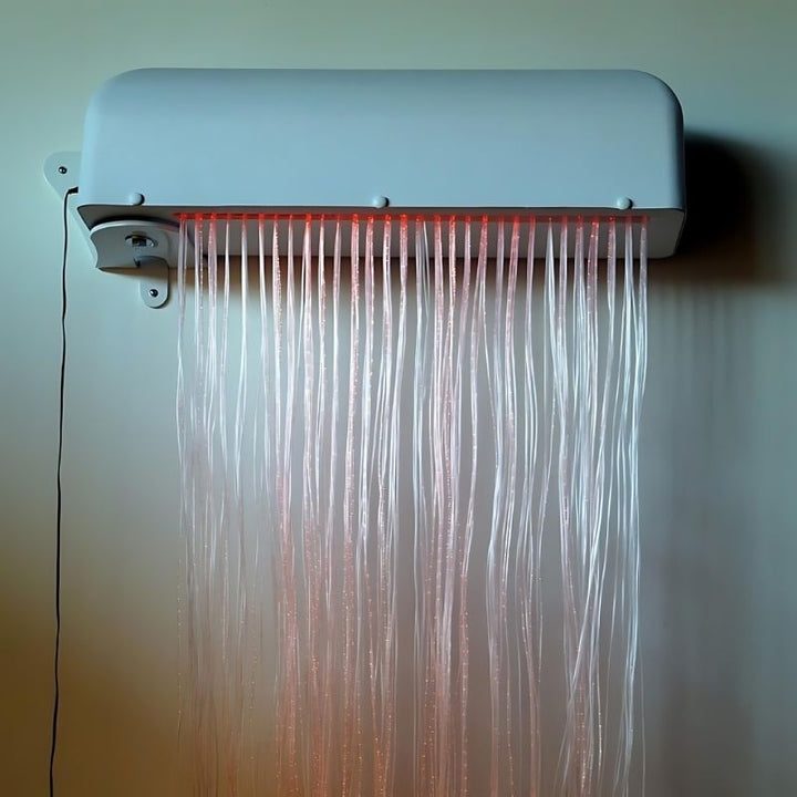 Close-up of the Experia LED Fibre Optic Wall Cascade installed on the wall, showing the 30-inch wide enclosure box and the LED fibre optic strands cascading from the base