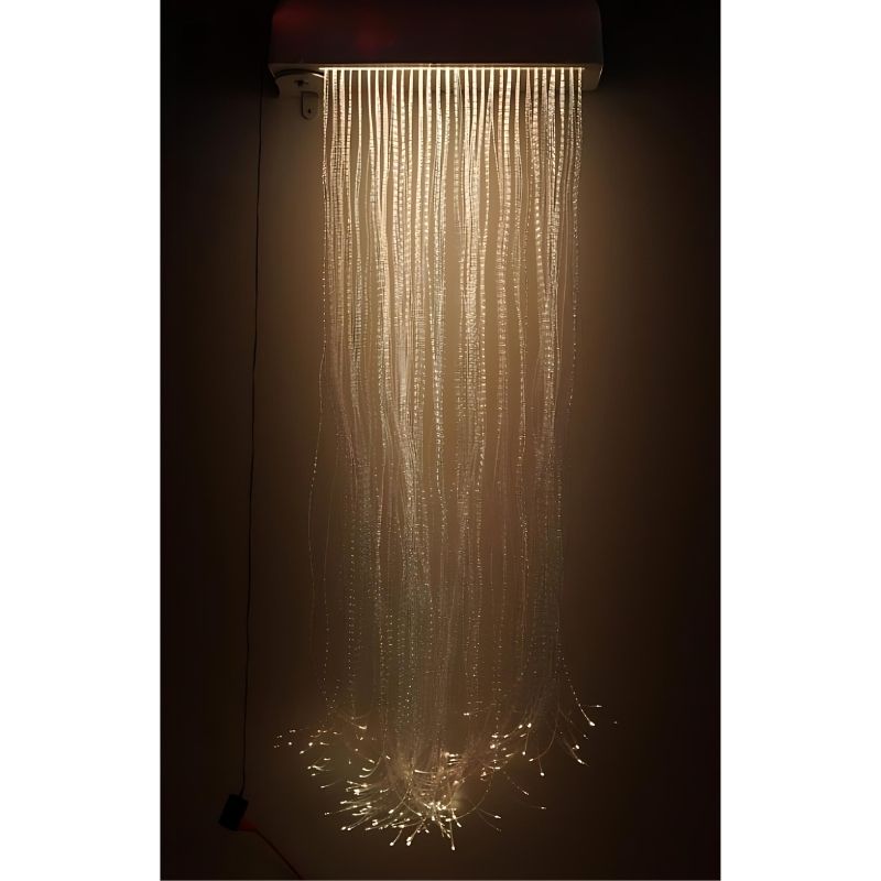 Experia LED Fibre Optic Wall Cascade front view in warm light showing the full 150-strand colour-changing fibre optic curtain cascading from the swiveling wall-mounted bracket