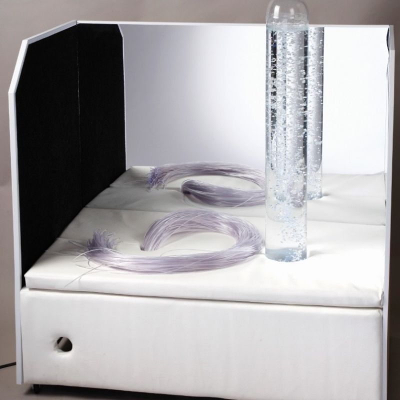 Experia Portable Sensory Corner Calming model front view, showing the wheeled vinyl platform with bubble tube, fibre optics, and mirrors forming a self-contained calming sensory environment