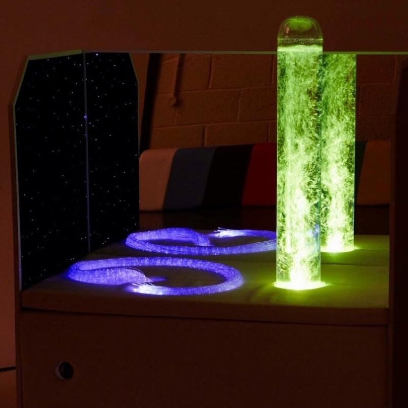 Experia Portable Sensory Corner Calming model with green bubble tube lighting and purple fibre optic carpet panel, showing the multi-colour sensory light output available