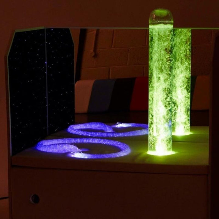 Experia Portable Sensory Corner Calming model with green bubble tube lighting and purple fibre optic carpet panel, showing the multi-colour sensory light output available