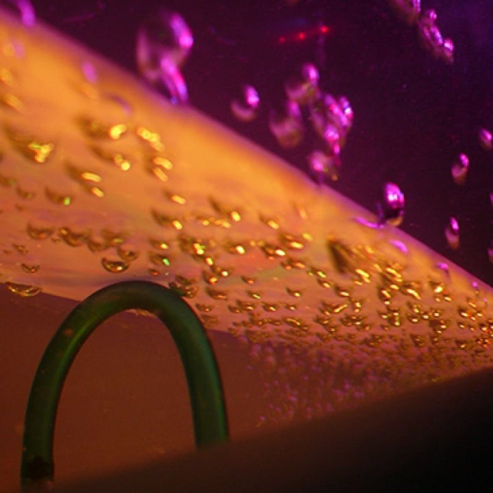 Close-up of the Experia Superactive LED Bubble Wall showing hundreds of rising bubbles across the wall-mounted LED sensory display surface