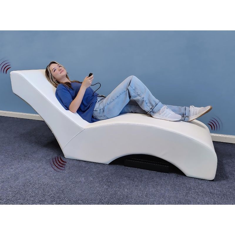 Experia Vibroacoustic Lounger landscape view showing a woman relaxing on the full-length Bluetooth vibroacoustic therapy lounger with Sound Bar configuration