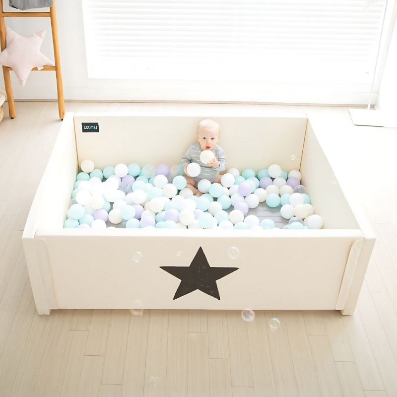 Top-down view of the Ggumbi Lucky Star Clean Bumper Play Room Extra Large Ivory with baby playing inside, showing the enclosed baby room yard configuration and interior play space