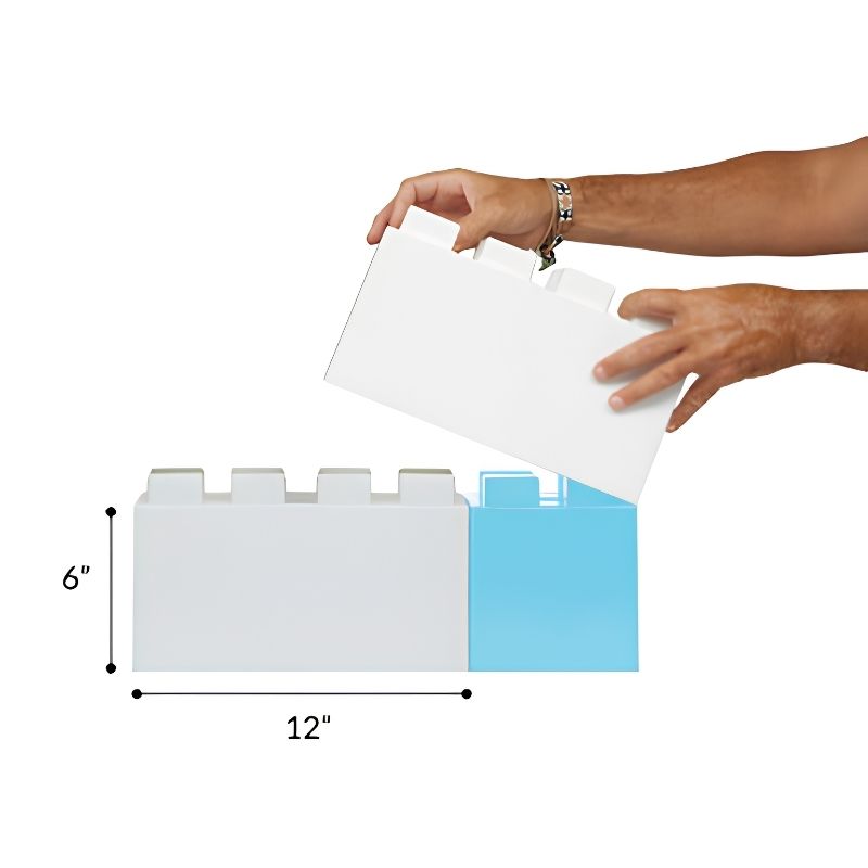 Hands holding a single full-size EverBlock giant building block measuring 12 inches long and 6 inches tall, part of the Large Starter Kit