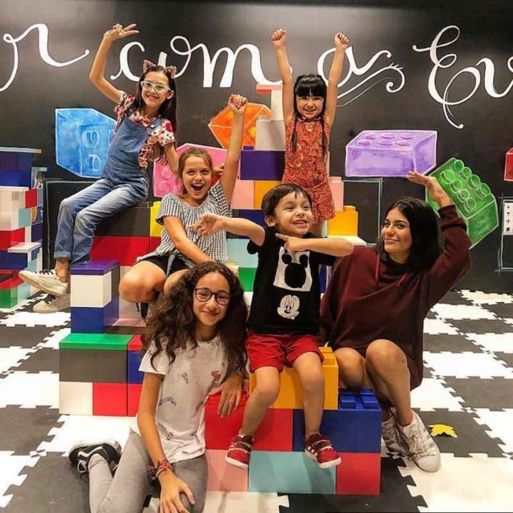 Children celebrating on an EverBlock giant building blocks display, a colourful STEM play setup for classrooms
