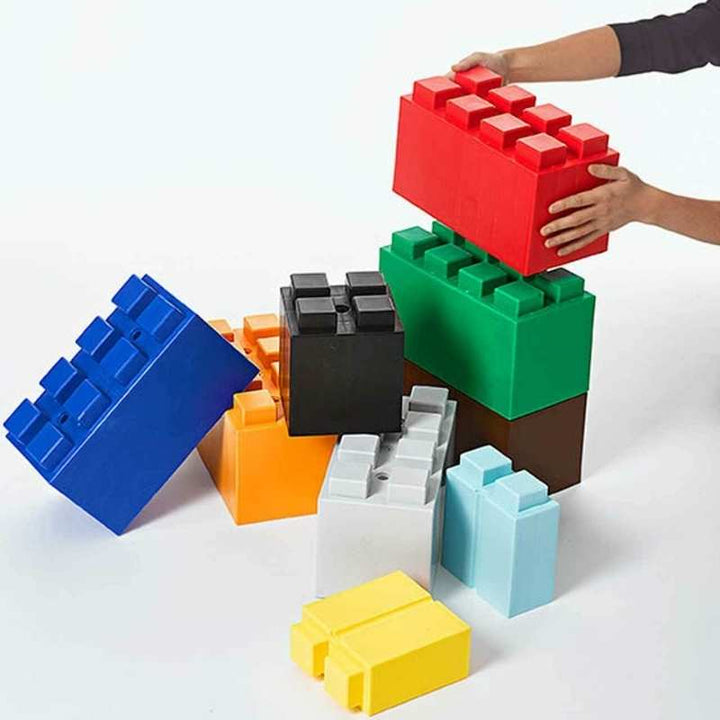  A hand stacking EverBlock giant building blocks, showing the modular pressure-fit design used in classroom STEM sets