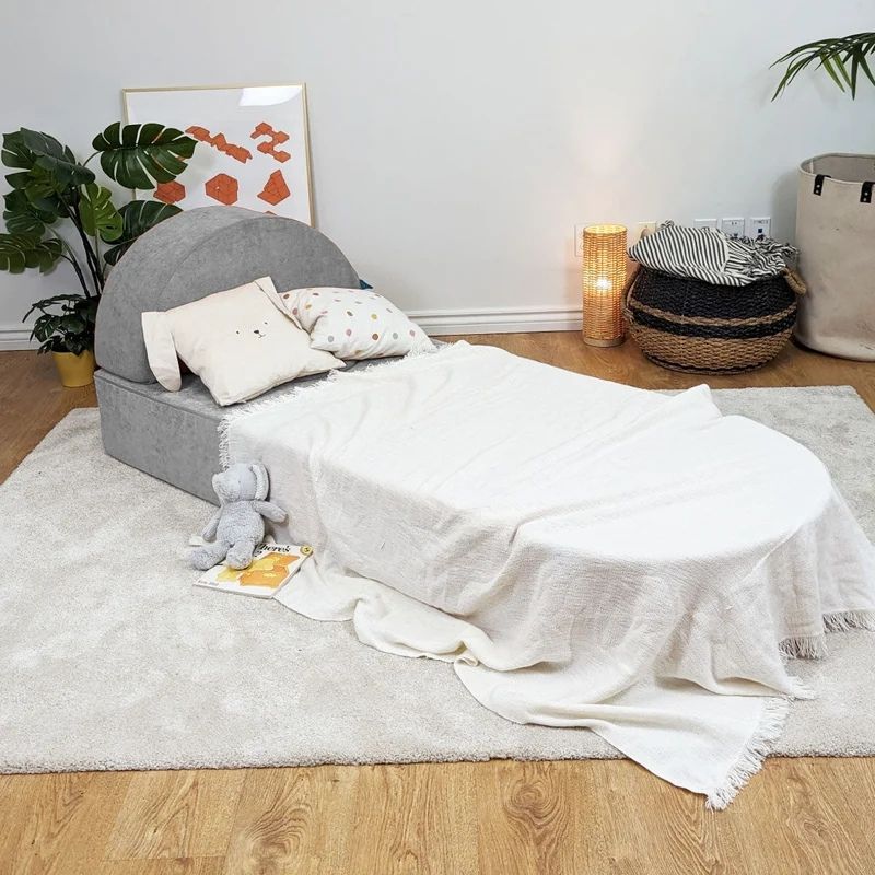 Go Coconut Architect Bundle configured as a bed or couch showing the thin base as a mattress layer and half-moon pieces as a curved headboard or canopy arch, demonstrating the furniture-style play configurations of the 8-piece modular foam play couch