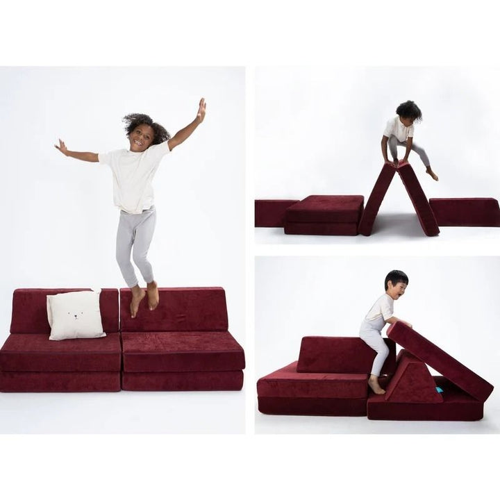 Children actively playing on Go Coconut - The Coconut in Cranberry Rain showing the open-ended modular foam configurations of the Montessori-inspired Canadian play couch