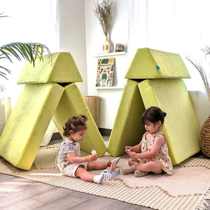 Two children actively playing on Go Coconut - The Coconut in Lima Limon demonstrating the creative modular building and gross motor play value of the Montessori-inspired Canadian-made play couch