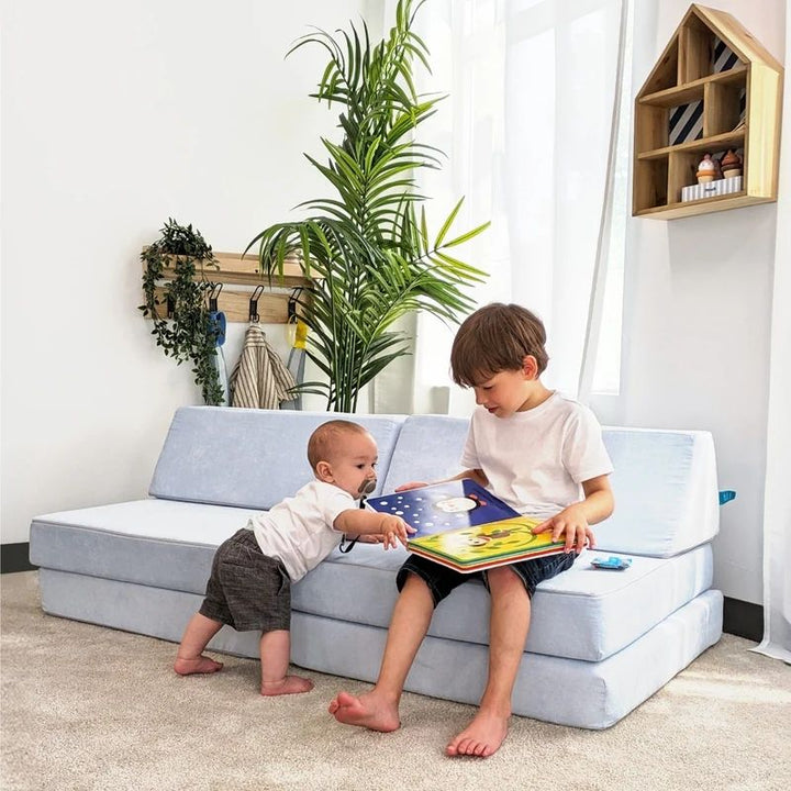 Two children actively playing on Go Coconut - The Coconut in Polar Plush demonstrating the shared creative play and sensory exploration enabled by the modular Canadian-made CertiPUR foam play couch