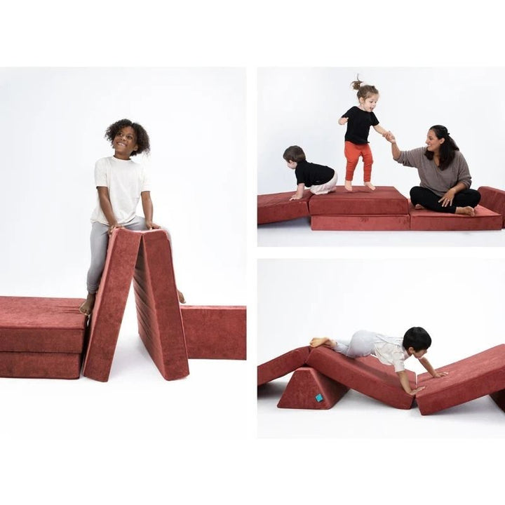 Children actively building and playing on Go Coconut - The Coconut in Red demonstrating the open-ended Montessori-inspired foam configurations of the 100% Canadian-made modular play couch