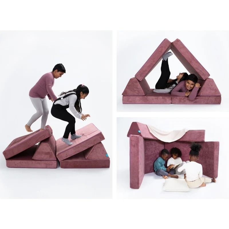 Children actively playing and building configurations on Go Coconut - The Coconut in Rose Blush demonstrating the open-ended Montessori-inspired modular design of the Canadian-made play couch