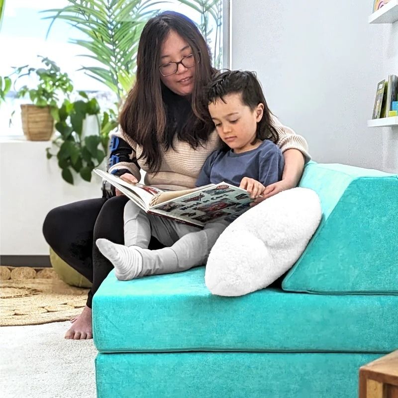 Mother and child enjoying Go Coconut - The Coconut play couch in Tropical Teal demonstrating the nesting and lounging comfort of the modular Canadian-made foam play couch for family use