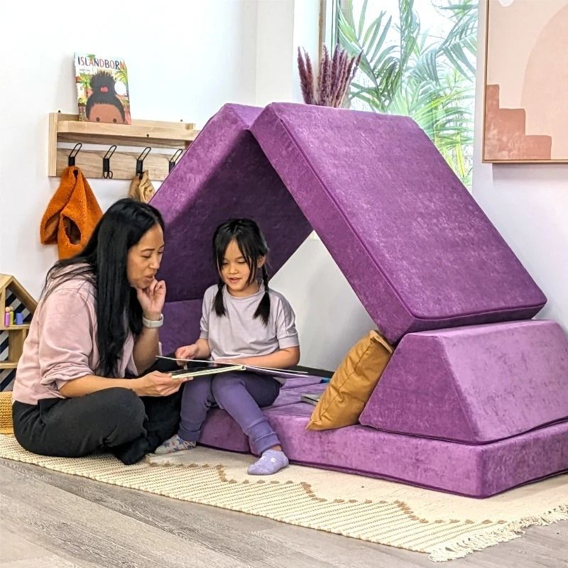 Mother and child lounging on Go Coconut - The Coconut play couch, demonstrating the deep pressure and nesting comfort of the CertiPUR-US certified Canadian foam for family use in a home living space