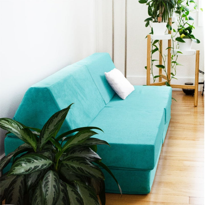 Go Coconut Half Coconut modular foam play couch shown from the side in a home indoor setting, ideal for small playrooms and sensory spaces