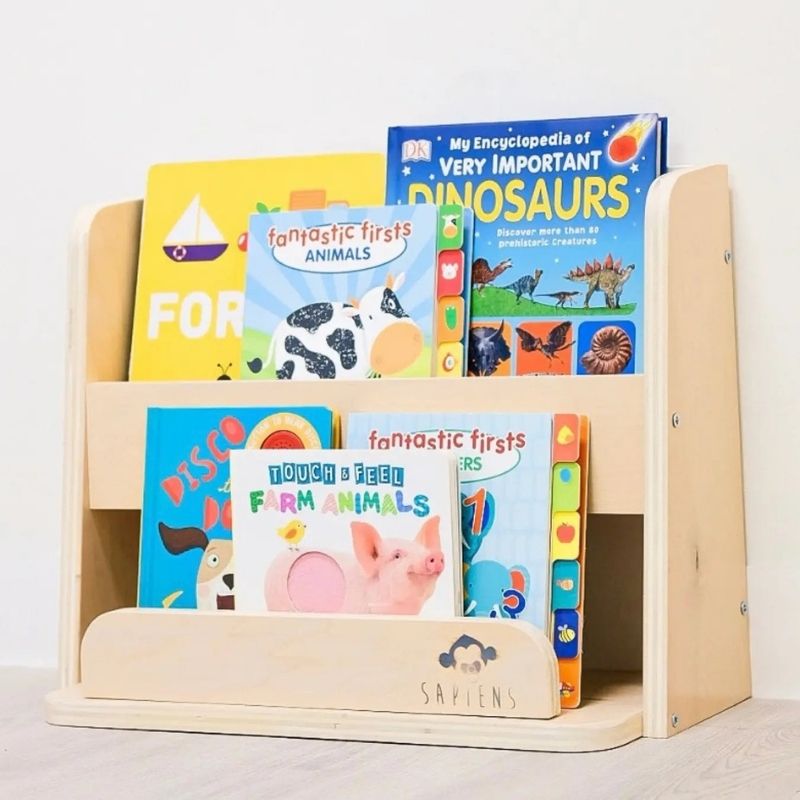 Sapiens Child Guava Montessori Bookshelf close-up indoor view showing the forward-facing book slots, rounded corners, and smooth non-toxic varnished finish of the Canadian-made toddler bookshelf
