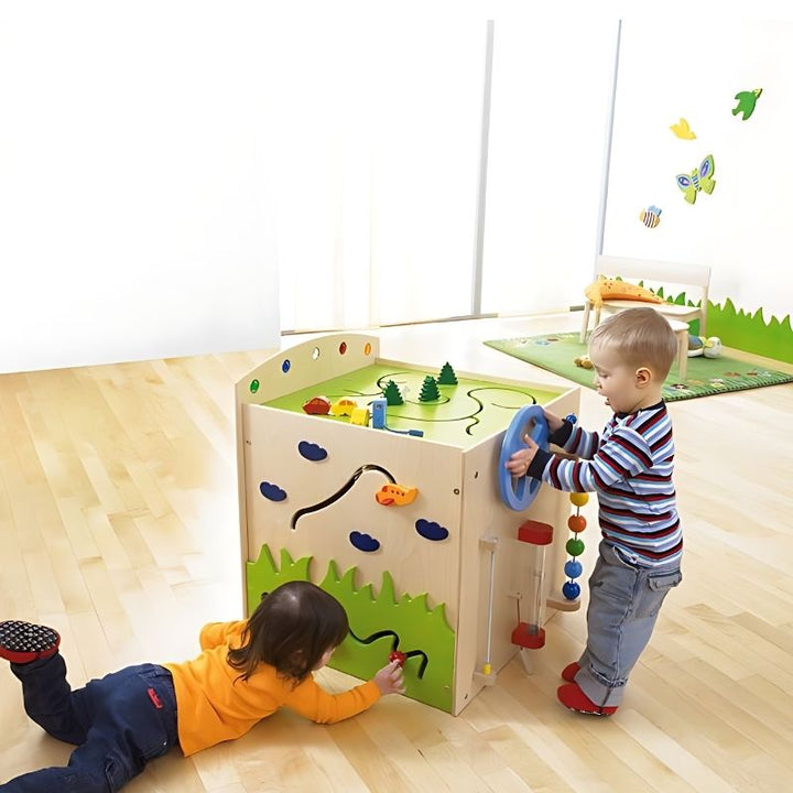 HABA Pro Multi Learning Cube sensory activities panel featuring spinning disc tower, magnifier, glitter rod and tactile surfaces - tactile and visual sensory input for therapy and classroom use